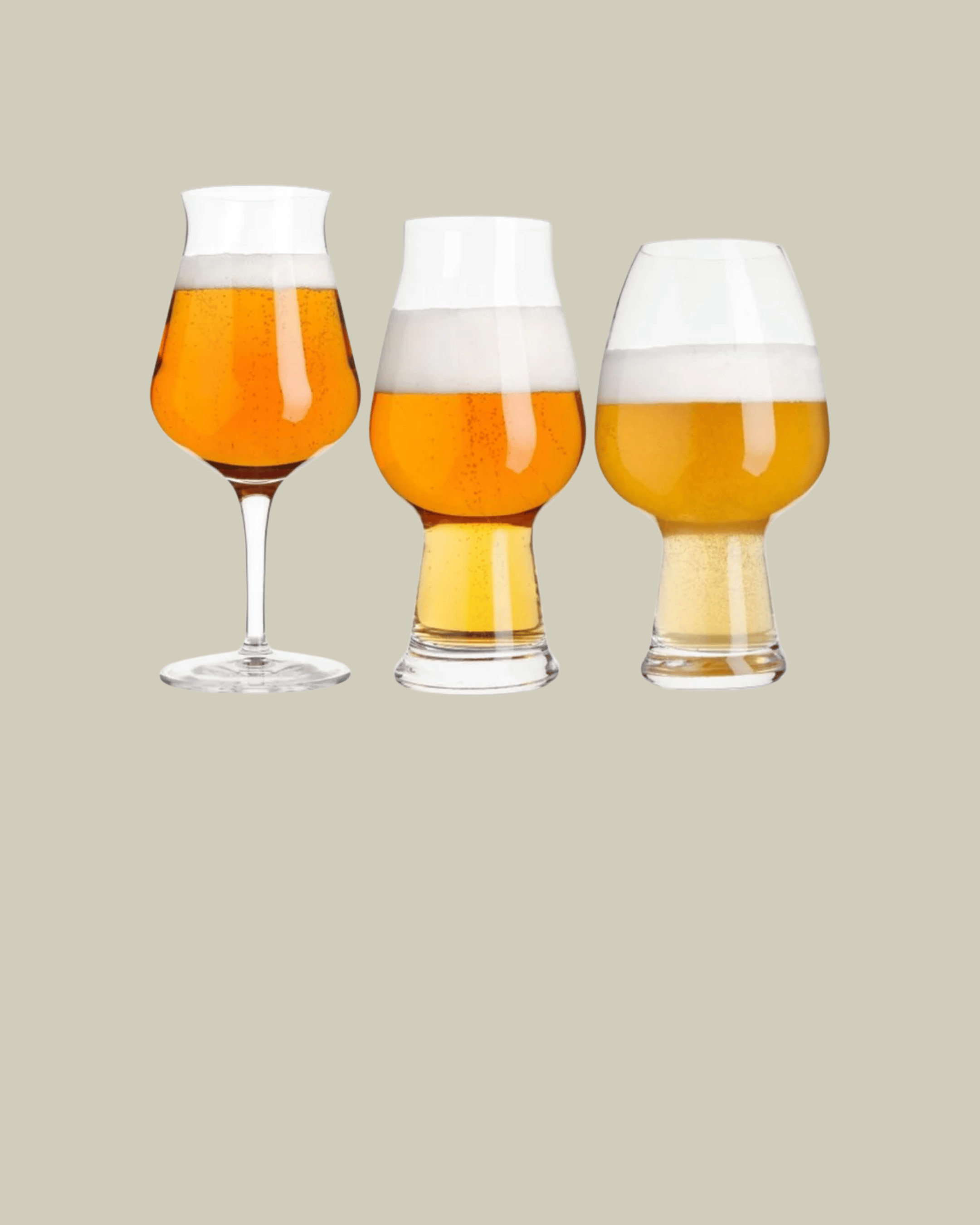 Three beer glasses with different types of beer on a beige background