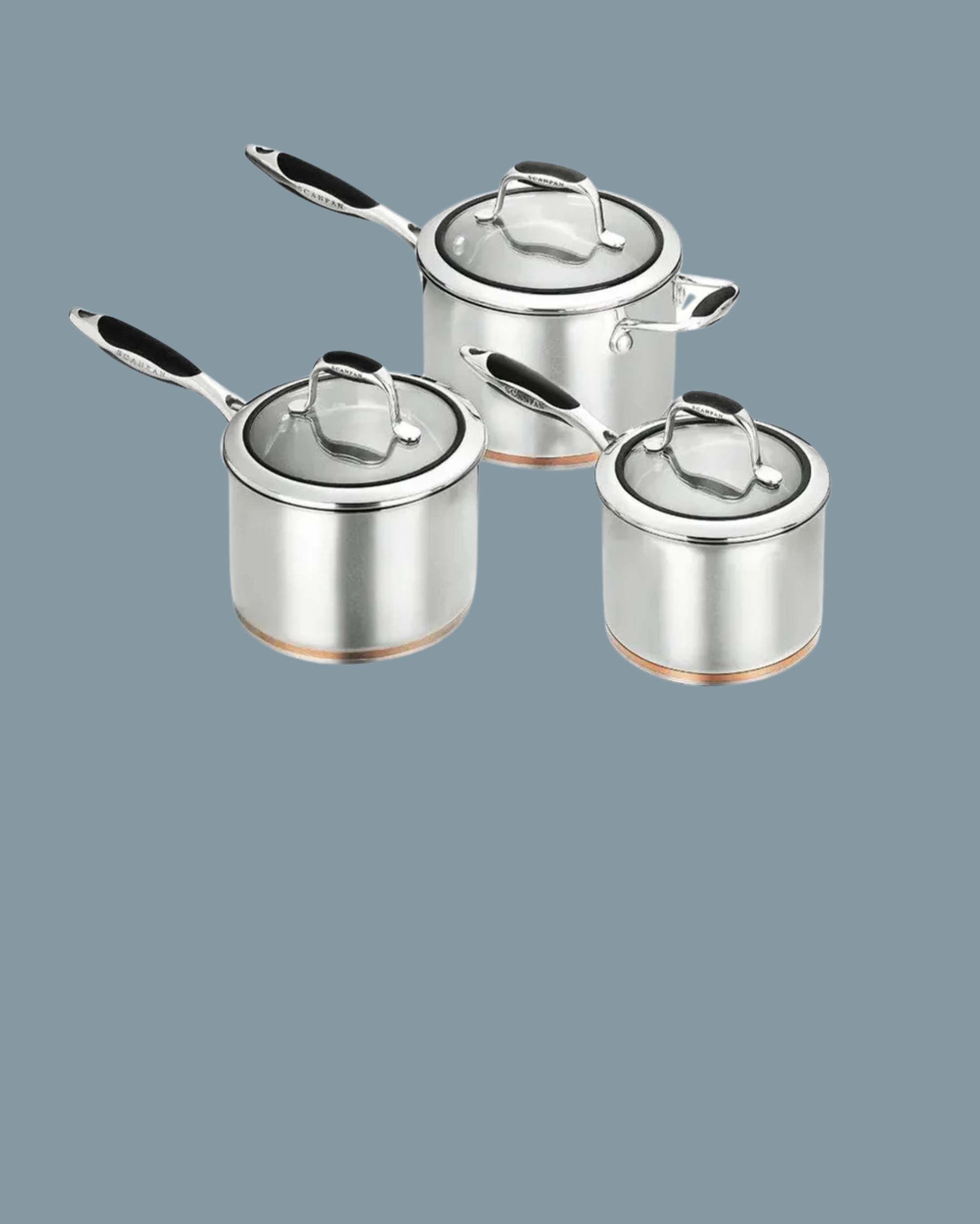 Set of four stainless steel cookware pots with lids on a gray background